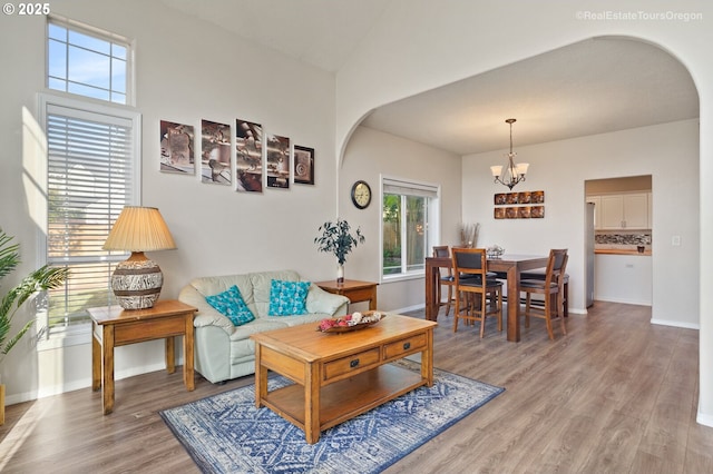 living room featuring a notable chandelier and light hardwood / wood-style floors