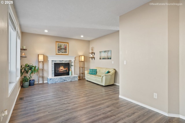 living room with hardwood / wood-style floors and a fireplace