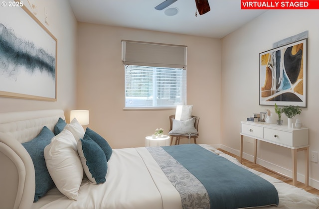 bedroom featuring wood finished floors and baseboards