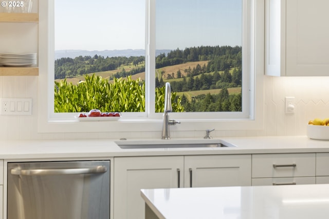 17385 NE Fairview Dr, Dundee, OR 97115 - kitchen with stainless steel dishwasher, a sink, white cabinets, light countertops, and healthy amount of natural light