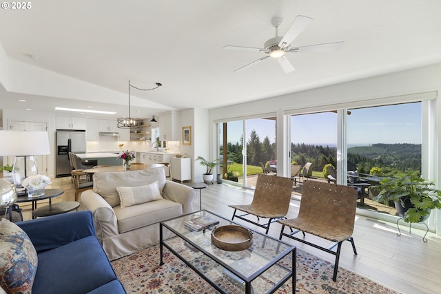 17385 NE Fairview Dr, Dundee, OR 97115 - living room with vaulted ceiling, light wood-type flooring, ceiling fan, recessed lighting, and a chandelier
