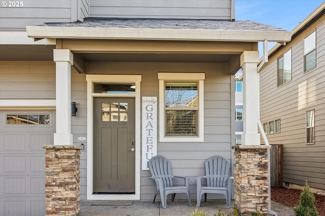 property entrance with a garage and covered porch