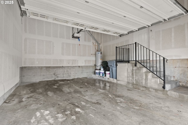 garage featuring water heater and a garage door opener
