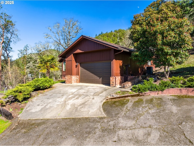 view of front of home featuring brick siding and driveway