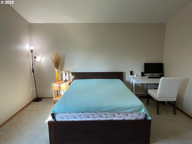 carpeted bedroom featuring baseboards