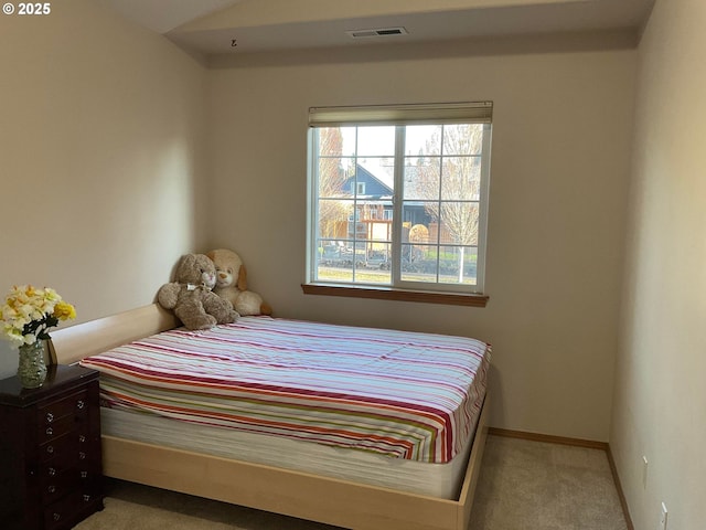 carpeted bedroom with baseboards, multiple windows, and visible vents