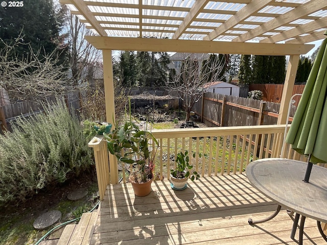 wooden terrace featuring a pergola and fence
