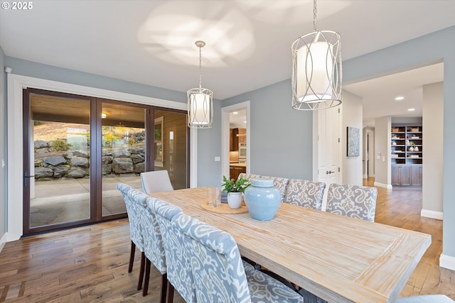 dining room with recessed lighting, baseboards, and hardwood / wood-style floors