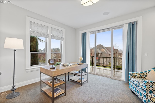 carpeted home office with plenty of natural light and baseboards