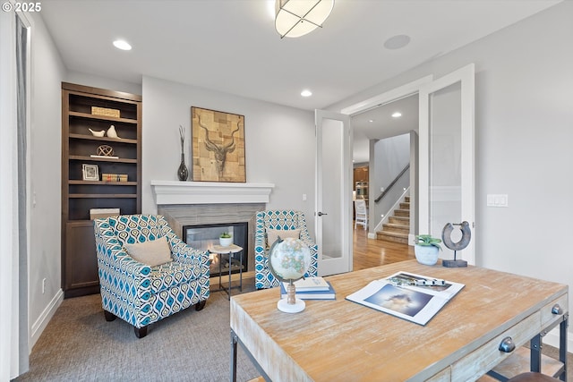 interior space with recessed lighting, stairway, and a glass covered fireplace