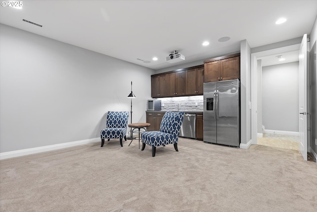 living area with recessed lighting, baseboards, and light carpet