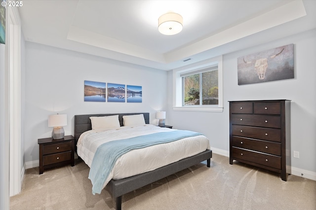 bedroom featuring visible vents, light colored carpet, and baseboards