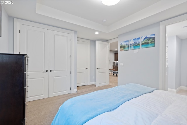 bedroom with recessed lighting, light colored carpet, a closet, and baseboards