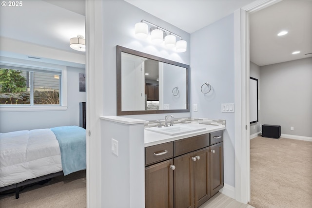 bathroom with recessed lighting, vanity, ensuite bathroom, and baseboards