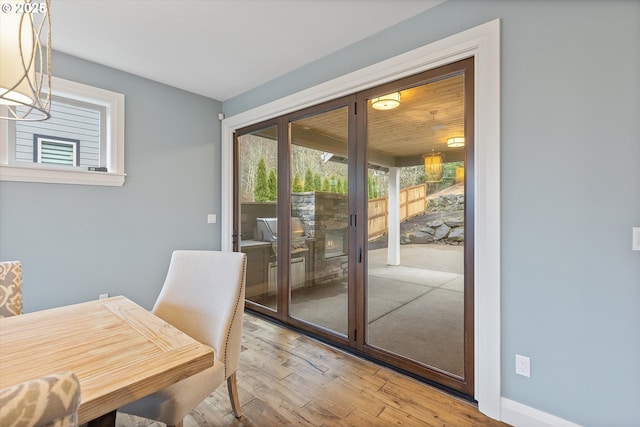 dining area with wood finished floors and french doors