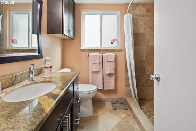 15580 SW Royalty Pkwy, Portland, OR 97224 - bathroom featuring vanity, toilet, tiled shower, and baseboards