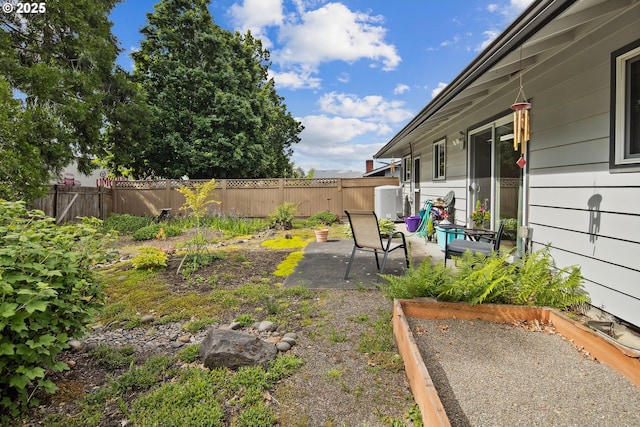 15580 SW Royalty Pkwy, Portland, OR 97224 - fenced backyard with a patio area and a vegetable garden