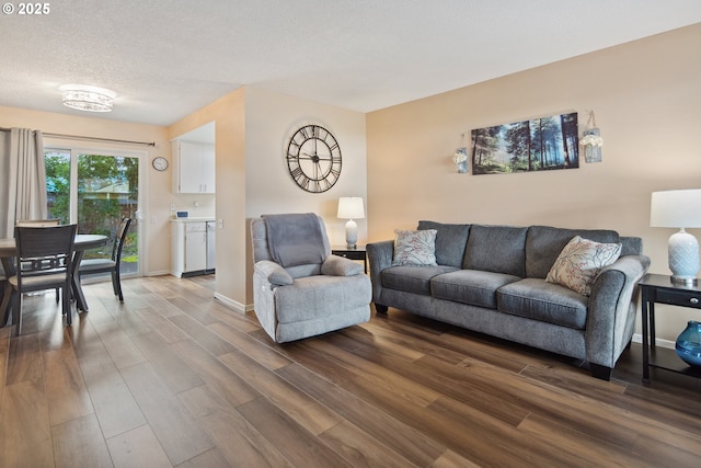 15580 SW Royalty Pkwy, Portland, OR 97224 - living room with dark wood-style floors, a textured ceiling, and baseboards