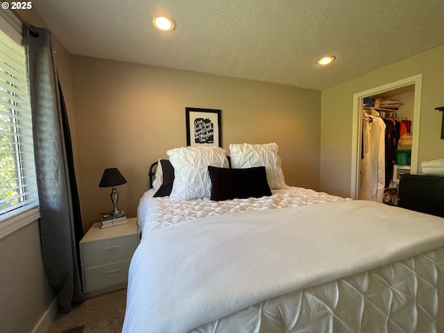 2145 Rock Ledge Dr, Keizer, OR 97303 - bedroom featuring recessed lighting, carpet flooring, a walk in closet, a textured ceiling, and a closet