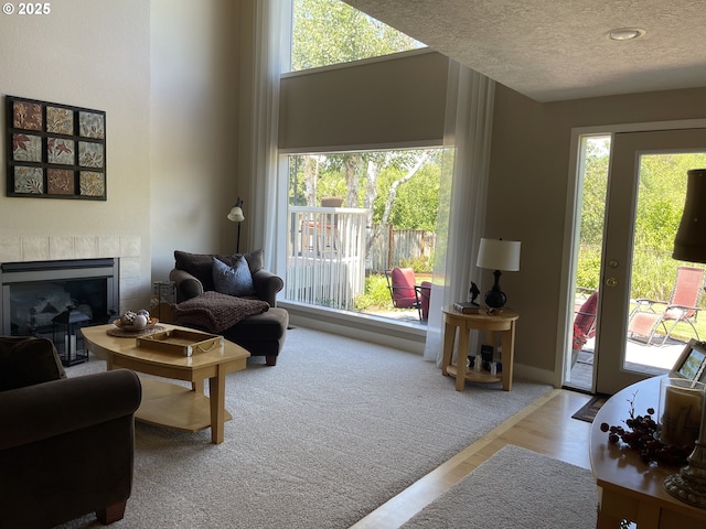 2145 Rock Ledge Dr, Keizer, OR 97303 - living area with healthy amount of natural light, a fireplace, a textured ceiling, and wood finished floors