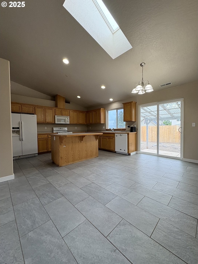 986 Arthur Ave, Cottage Grove, OR 97424 - kitchen featuring white appliances, a chandelier, a skylight, recessed lighting, and lofted ceiling
