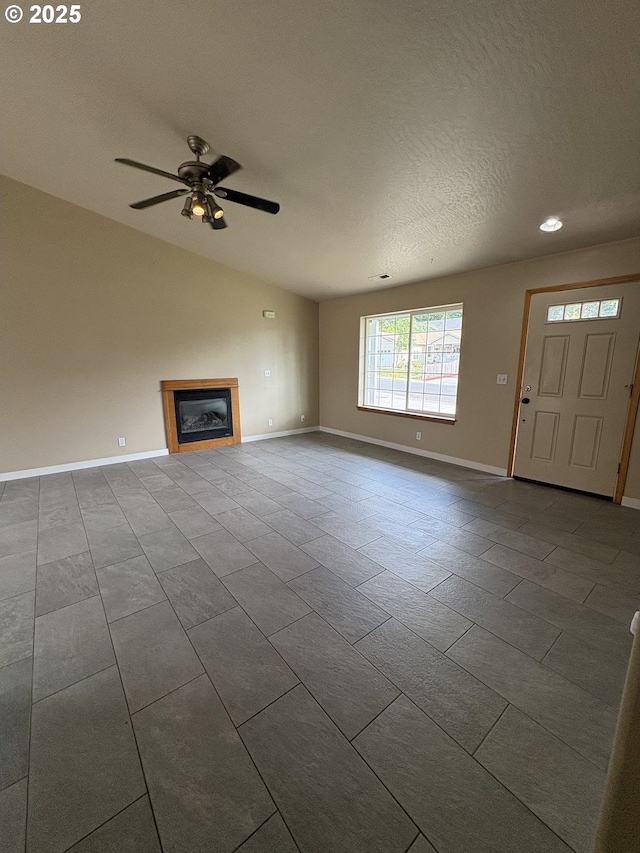 986 Arthur Ave, Cottage Grove, OR 97424 - unfurnished living room with a glass covered fireplace, a ceiling fan, dark tile patterned flooring, recessed lighting, and a textured ceiling