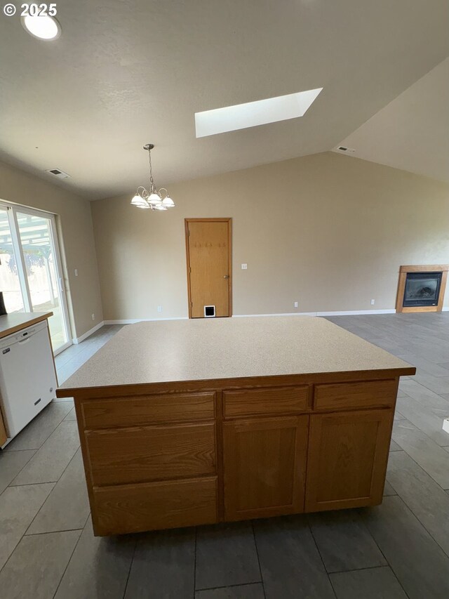 986 Arthur Ave, Cottage Grove, OR 97424 - kitchen with white dishwasher, a skylight, open floor plan, a chandelier, and light countertops