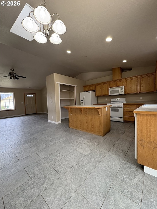 986 Arthur Ave, Cottage Grove, OR 97424 - kitchen with white appliances, light countertops, open floor plan, a center island, and brown cabinets