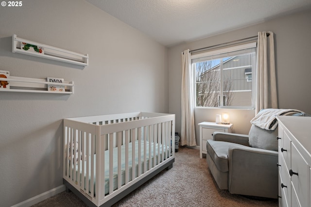 carpeted bedroom with a nursery area, a textured ceiling, and vaulted ceiling