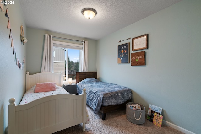 carpeted bedroom featuring a textured ceiling