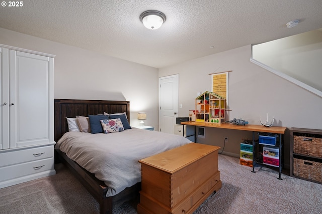 bedroom with a textured ceiling and carpet floors