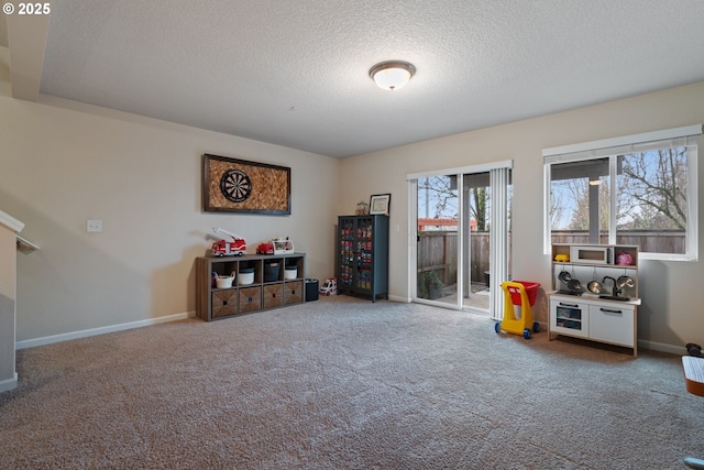 misc room with a textured ceiling and carpet flooring