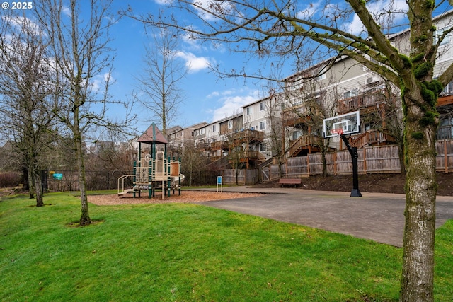 exterior space with basketball court and a playground