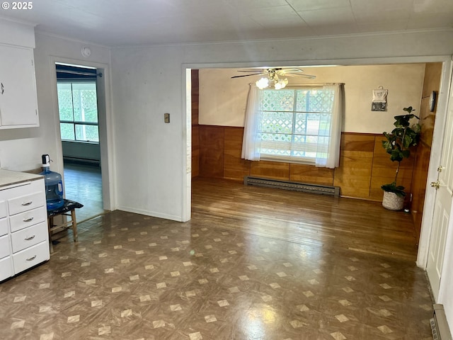 21223 NW Bendemeer Rd, Hillsboro, OR 97124 - unfurnished dining area featuring a baseboard heating unit, ornamental molding, tile patterned floors, wainscoting, and a ceiling fan