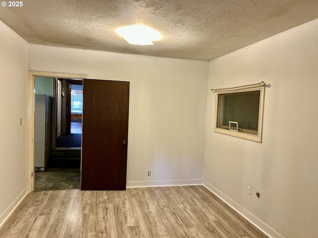 21223 NW Bendemeer Rd, Hillsboro, OR 97124 - spare room featuring wood finished floors and a textured ceiling