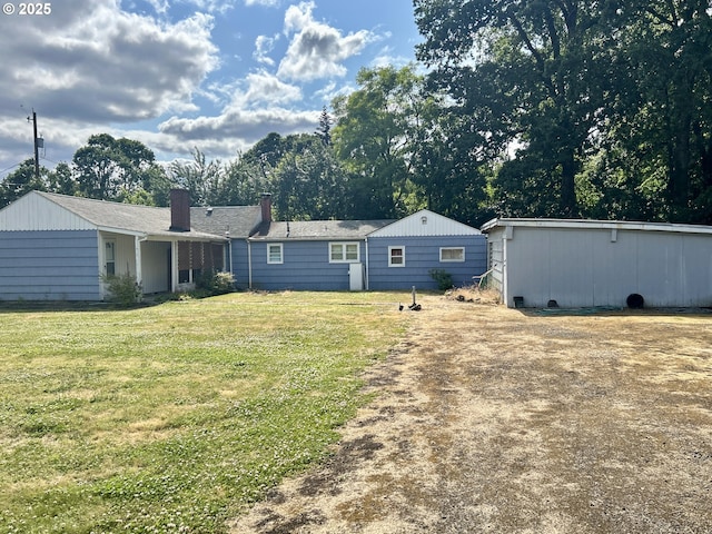 21223 NW Bendemeer Rd, Hillsboro, OR 97124 - rear view of house with a yard, a chimney, and view of wooded area