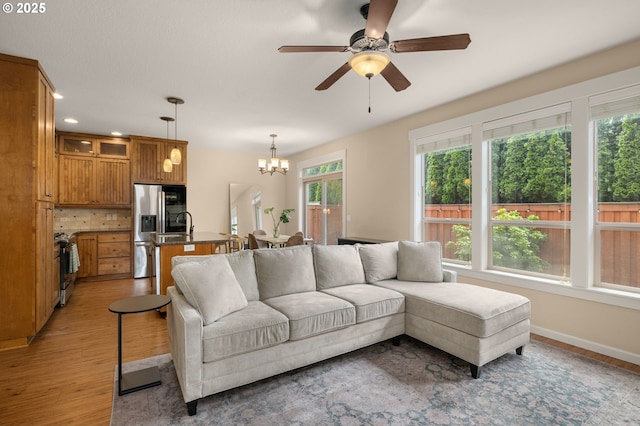 17760 SW Robert Ln, Beaverton, OR 97078 - living room with a chandelier, light wood-style flooring, ceiling fan, and recessed lighting