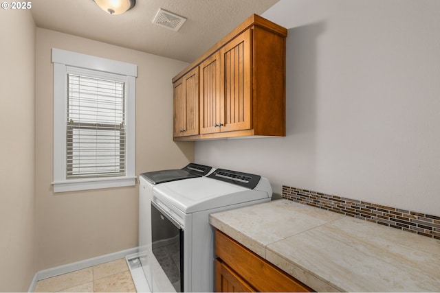 17760 SW Robert Ln, Beaverton, OR 97078 - washroom with independent washer and dryer, cabinet space, and light tile patterned floors