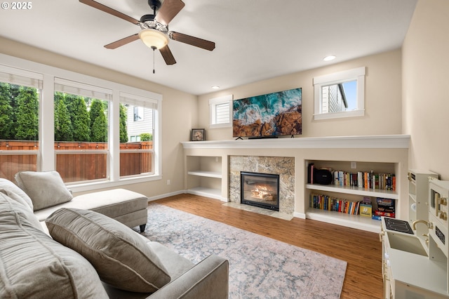 17760 SW Robert Ln, Beaverton, OR 97078 - living area with healthy amount of natural light, wood finished floors, a premium fireplace, ceiling fan, and recessed lighting