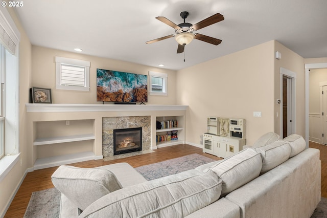 17760 SW Robert Ln, Beaverton, OR 97078 - living room with ceiling fan, wood finished floors, a fireplace, and healthy amount of natural light