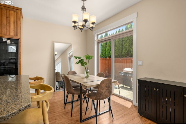 17760 SW Robert Ln, Beaverton, OR 97078 - dining area with plenty of natural light, a chandelier, and light wood-type flooring
