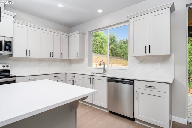 1624 NE Josephine Ct Unit 177, Estacada, OR 97023 - kitchen with appliances with stainless steel finishes, a sink, light countertops, recessed lighting, and backsplash