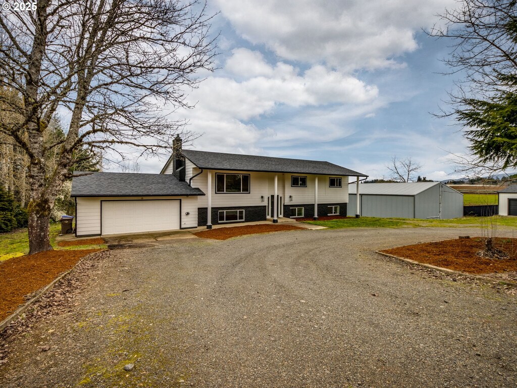 33133 SE Dodge Park Blvd, Gresham, OR 97080 - split foyer home featuring gravel driveway and a garage
