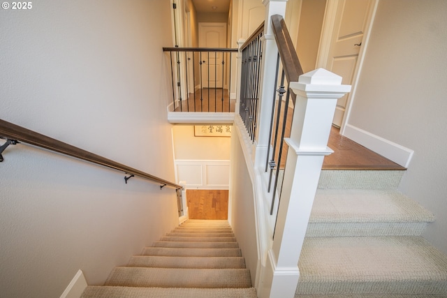 stairs featuring wood finished floors