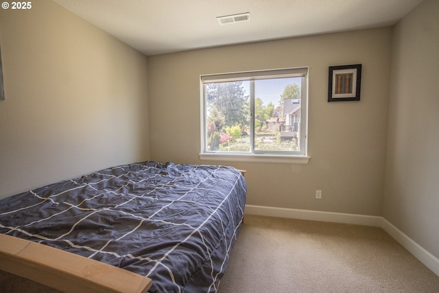 bedroom with baseboards, visible vents, and carpet flooring