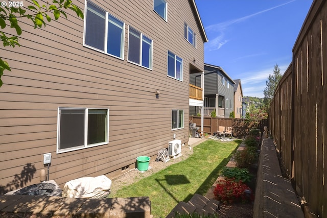 view of side of property featuring a yard, a patio, crawl space, a residential view, and a fenced backyard