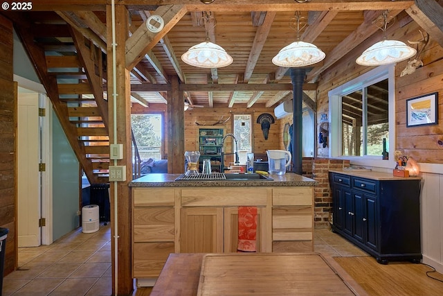 83863 Ollokot Ln, Joseph, OR 97846 - kitchen with a sink, wooden ceiling with exposed beams, wood walls, light tile patterned flooring, and pendant lighting