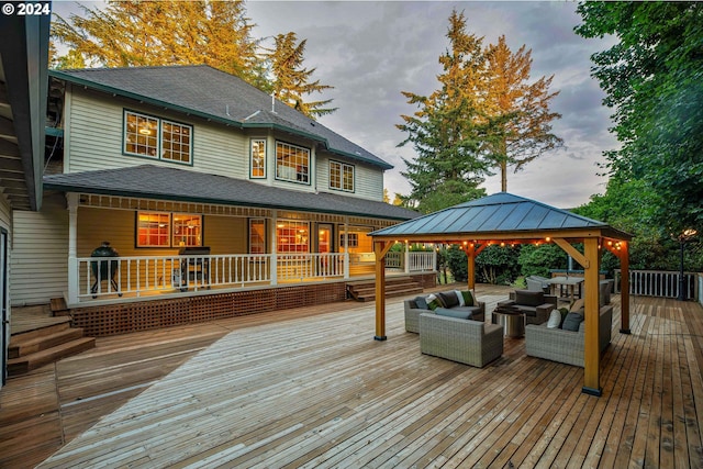 wooden terrace featuring a gazebo and an outdoor hangout area