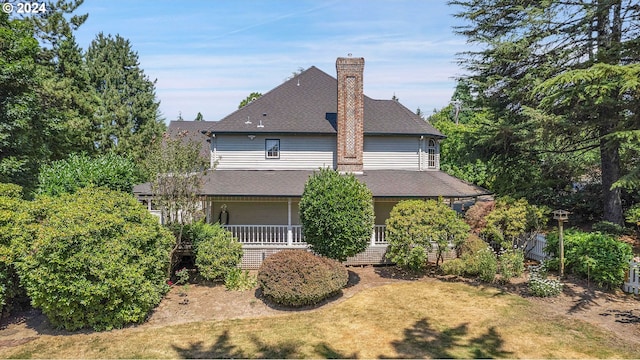 rear view of property with a yard