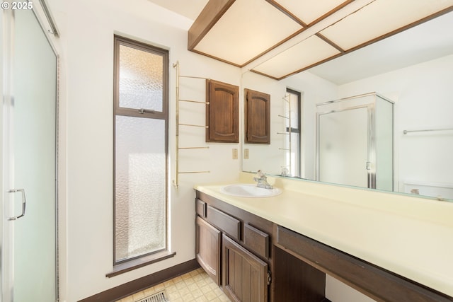 bathroom with vanity and a shower with shower door